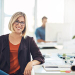 Portrait of a young woman working at her desk in a modern office