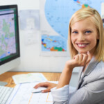 A beautiful young woman planning an overseas trip on the internet